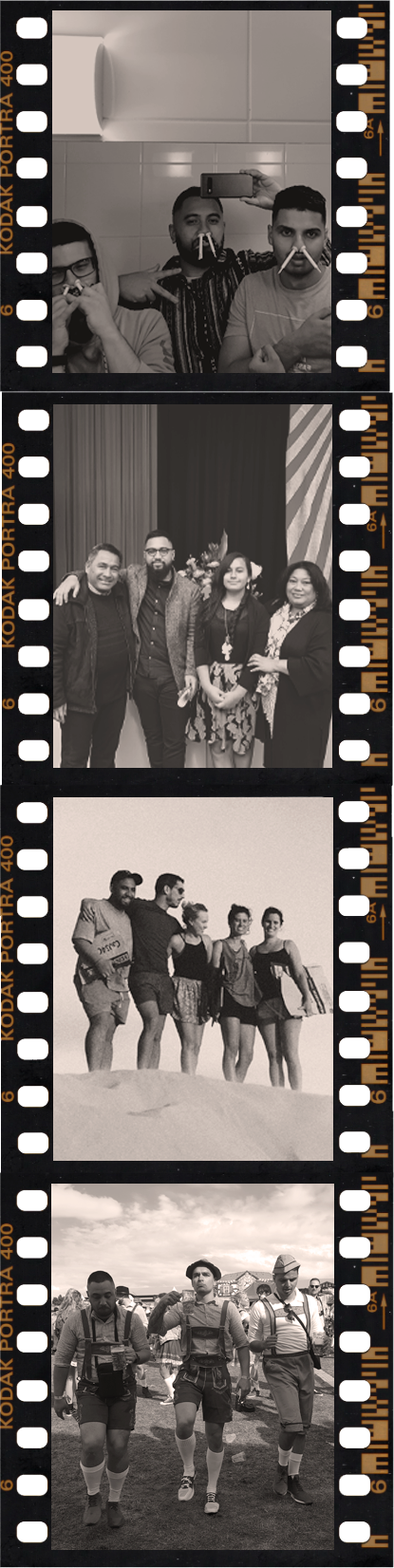 A strip of four black-and-white frames on Kodak Portra 400 film: group shots of people pulling faces at a table, posing together indoors, standing on a sand dune, and walking in lederhosen