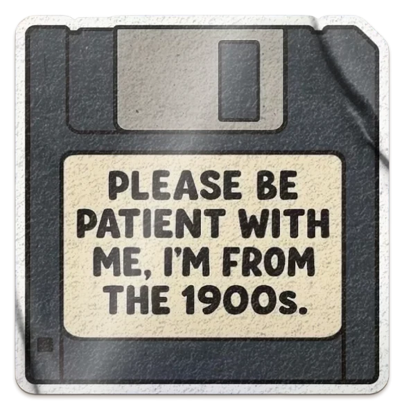 A die-cut sticker of a black 3.5-inch floppy disk whose label reads Please be patient with me, I'm from the 1900s.