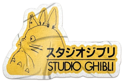 A die-cut Studio Ghibli sticker: Totoro's outline on yellow beside スタジオジブリ and STUDIO GHIBLI