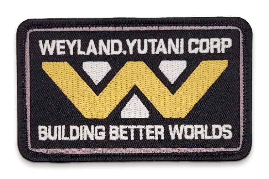 An embroidered black Weyland-Yutani Corp patch with the gold W logo and the line Building Better Worlds